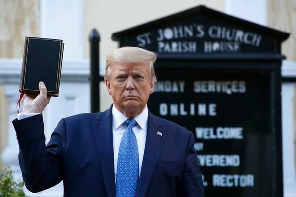 photo - Donald Trump walked to the church to pose for photos, holding a bible aloft. Credit: AP